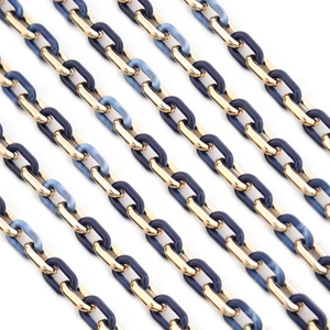 Detail view of gold metal and blue marble acrylic chain links for necklaces and accessories