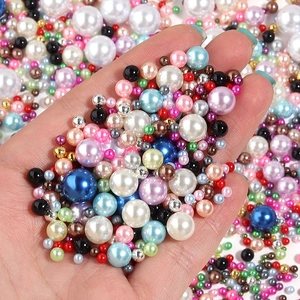 Close-up of colorful mixed size ABS faux pearls in multiple vibrant colors for DIY crafts