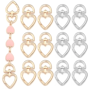 Flat lay of heart-shaped zinc alloy lobster clasps in gold and silver with pink charm