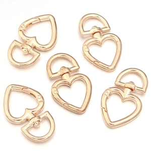 Detail of rose gold heart-shaped metal lobster clasps for DIY jewelry and bag accessories