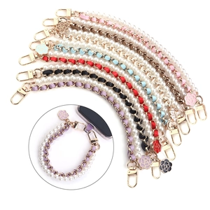Elegant pearl and gold chain strap with camellia charms and colorful leather accents