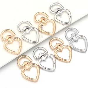 Macro shot of gold and silver heart-shaped zinc alloy lobster clasps for bags