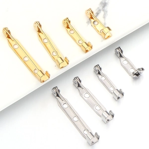 Macro view of gold and silver stainless steel brooch pin bases for DIY jewelry making