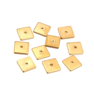 Macro view of ten gold square spacer beads for DIY jewelry making and bracelet assembly