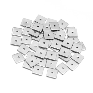 Macro shot of silver stainless steel square spacer beads with center holes for DIY jewelry
