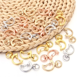 Macro detail of crescent-shaped zinc alloy lobster clasps in gold, silver, and rose gold