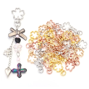 Detailed view of Sakura flower lobster clasps and DIY charms in various metallic finishes
