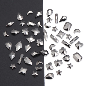 Macro detail of various black crystal nail art rhinestones with multifaceted geometric cuts