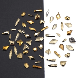 Close-up of golden champagne rhinestones with multi-facet cuts for DIY nail art
