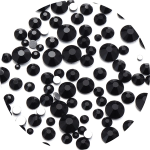 Macro view of multi-sized black faceted glass rhinestones with silver flat back design