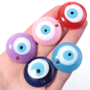 Close-up of five colorful evil eye resin pendants in red, pink, purple, and blue colors