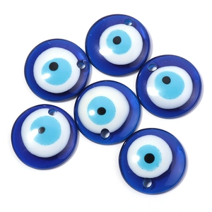 Close-up of six translucent blue Evil Eye beads for DIY jewelry making and crafts