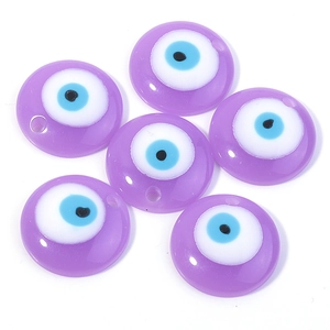 Close-up of six purple evil eye flat round resin beads with pre-drilled holes for DIY jewelry
