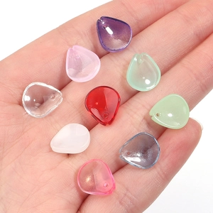 Macro detail of various colorful translucent plum petal beads for DIY jewelry making