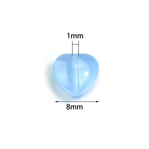 Close-up of 8mm light blue glass heart bead with 1mm vertical hole for DIY jewelry