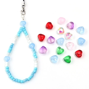 Detail of colorful gradient glass heart beads for DIY jewelry and beaded phone charms
