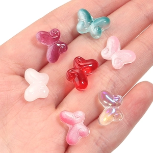 Detailed macro shot of various colorful butterfly resin beads for DIY jewelry making