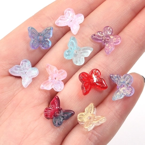 Close-up of colorful gradient butterfly beads with glitter for DIY jewelry making
