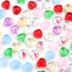 Macro shot of colorful glass heart beads with holes for DIY jewelry and crafts making