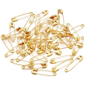 Close-up of bulk gold bulb safety pins for DIY crafts and garment fastening