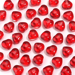 Close-up of vibrant red heart-shaped glass beads with center holes for DIY jewelry