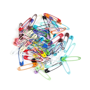 Close-up of assorted colorful iron safety pins with vibrant painted finish for DIY crafts