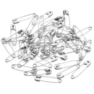 Close-up of bulk silver iron safety pins for DIY crafts and clothing accessories