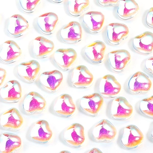 Macro view of gradient heart-shaped glass beads with AB iridescent finish and center hole