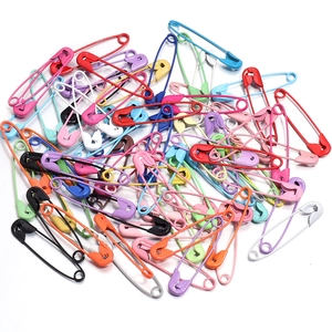 Macro view of assorted colorful coated metal safety pins for DIY crafts and accessories