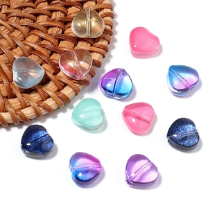Macro shot of colorful gradient glass heart beads with holes for DIY jewelry making