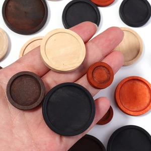 Macro view of assorted round wooden bezel trays for DIY jewelry making in multiple finishes