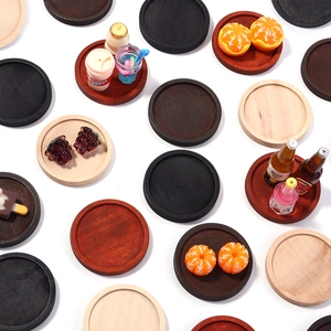 Macro detail of round wooden jewelry trays in various natural wood grain finishes