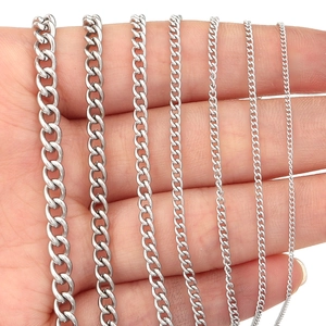 Polished stainless steel curb chains in seven sizes displayed on hand for scale