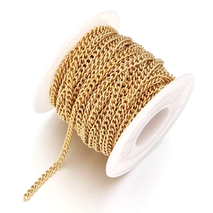 Detailed view of bulk gold plated stainless steel curb chain on white plastic spool