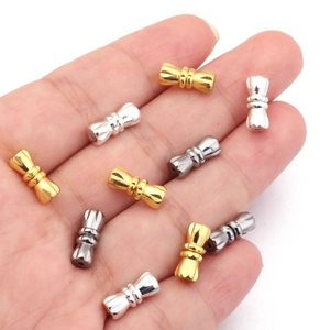Detailed view of 11mm brass peanut clasps in gold, silver, and gunmetal on a palm