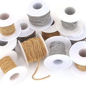 Detail view of bulk stainless steel curb chains in gold and silver finish on spools