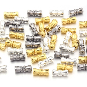 Macro detail of 11mm peanut-shaped brass spiral connectors for DIY jewelry making
