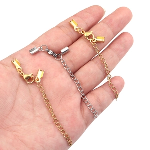 Gold and silver stainless steel lobster clasp and extension chain sets held in hand