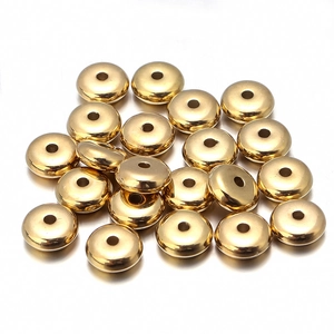 Close-up of golden CCB spacer beads with polished mirror finish for DIY jewelry