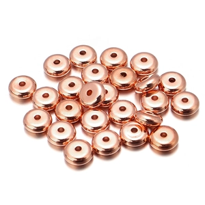 Close-up of rose gold rondelle spacer beads with smooth finish for DIY jewelry