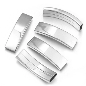 Macro view of five curved stainless steel tube connectors with engraved material logo