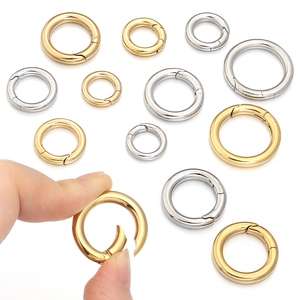 Detailed macro view of gold and silver plated spring ring clasps in various sizes for DIY