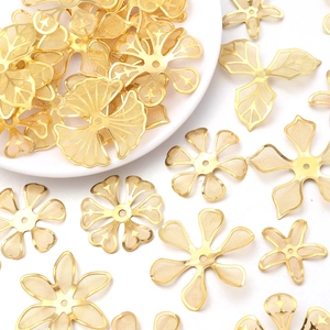 Gold plated copper wire flower and leaf charms for DIY jewelry making on white background