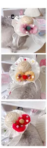 Detail of straw pet hat with colorful pompoms and lace ruffle for cats and small dogs
