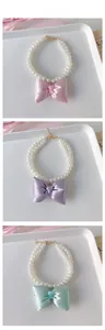 Close-up of double-layered pearl pet necklaces with bows in pink, purple and mint green