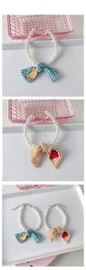 Detail of adjustable pet pearl collar with fruit embroidery bow and metal lobster clasp