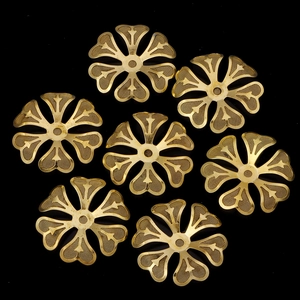Detailed view of golden metal mesh flower charm for DIY jewelry and handmade crafts