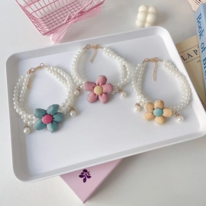 Detail of double-layer pet pearl necklaces with colorful fabric flowers and adjustable clasps