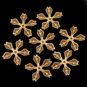 Macro shot of seven gold-plated copper filigree flower petals for DIY jewelry making