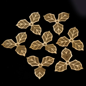 Detailed view of golden hollow filigree flower petals for DIY jewelry making accessories